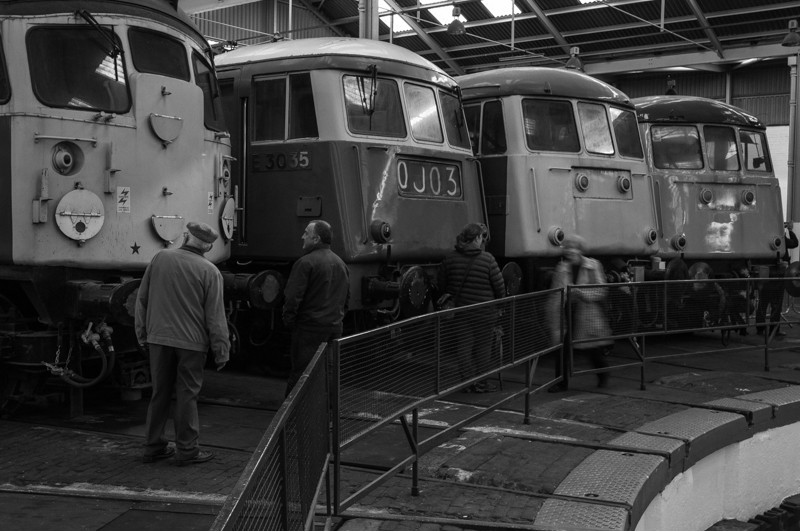 Barrow Hill is Back!
After being closed for a refurbishment, Barrow Hill depot is back open to the public; thankfully the atmosphere that made it so special has been retained. A Class 26 and AC electrics stand around the turntable.
