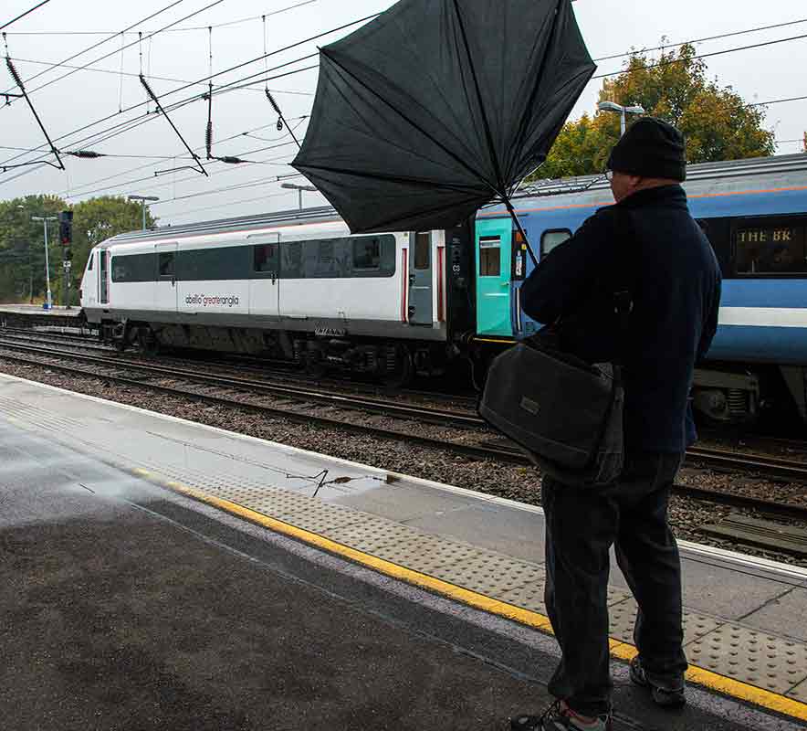 A Put-up Job 
John struggles manfully with the wind.
