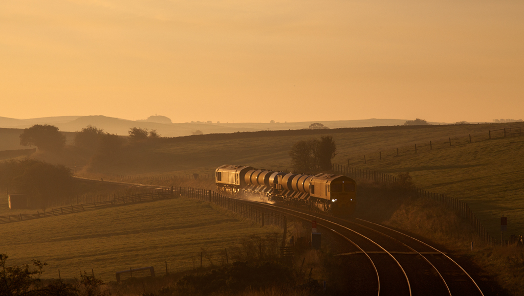 Sunrise sprayer
Train 3J11, the 1620 Carlisle - Carlisle via most of Cumbria and north Lancashire approaches Clapham on the Skipton - Carnforth leg of it's mammoth 21 hour mission to clear the rail head of autumn leaves. 
