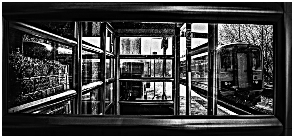 No Takers
Dirty windows on Builth Road's "bus shelter" waiting room, and no passengers boarding or alighting the mid afternoon service to Swansea.

This modern structure replaces the former station house, a substantial building which was converted to residential accommodation some time ago.
