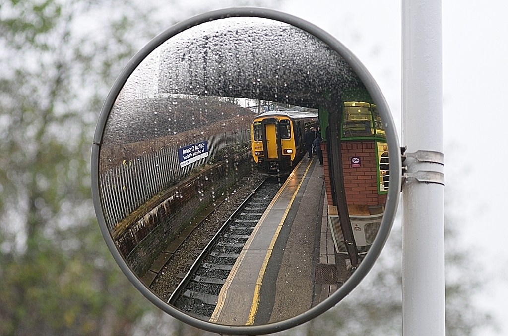 Reflections at Salford
A Class 156 unit awaits departure from Salford crescent with a Hazel Grove - Preston service.
