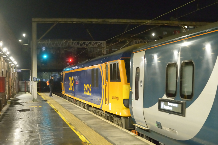 Night Shift
The crew of class 92 92028 exchange greetings at Preston during a crew change whilst working the overnight Euston - Aberdeen / Fort William / Inverness sleeper service.  
