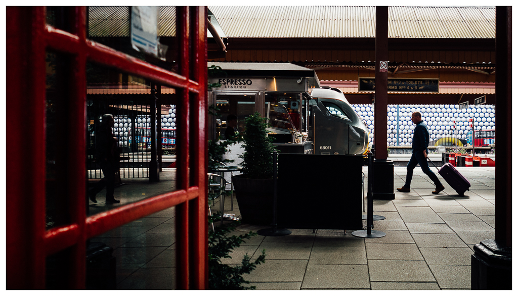Want Coffee
With a purpose, a guys strides towards the the platform coffee shop. In the background 68011 bides its time before heading for London.

