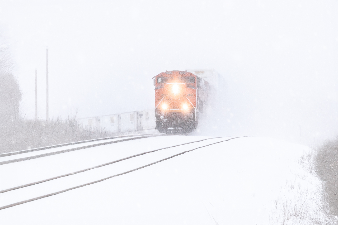 Blowing snow and bitter cold
A high-priority double-stack intermodal train bound for California is climbing out of the James River Valley at Turners in southwest Missouri.  A major snowstorm that affected over thirty of the fifty states dumped almost a foot of cold, dry snow in Springfield.  With a temperature of -8 Fahrenheit, a 15-20 mph wind, and heavy snowfall, it didn't take much to disturb the powdery snow and reduce the visibility even more.
