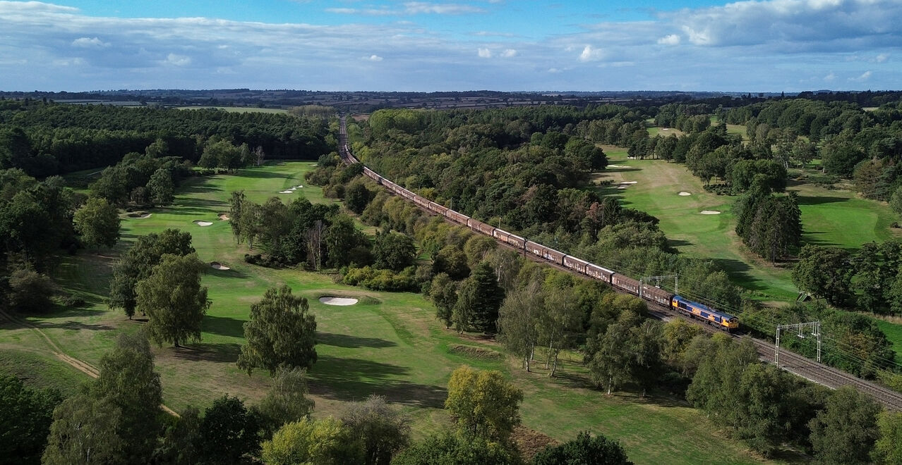 Water Hazard
GBRf's 66687 passes through the Northamptonshire County Golf Club near Church Brampton. The service is 6O55 Daventry - Dollands Moor conveying empty bottled water vans back to France for replenishment.
