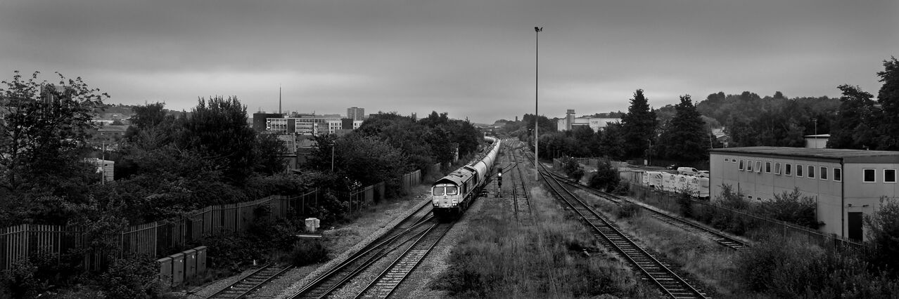 It wasn't always sunny.....
A Clitheroe-Avonmouth cement train picks its way through Blackburn on a cloudy, muggy morning at the height of the July heatwave. The forecast thunderstorms failed to materialise.
